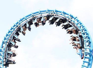 blue rollercoaster loop the loop with cloudy sky 1