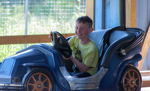 Young boy in dodgem car
