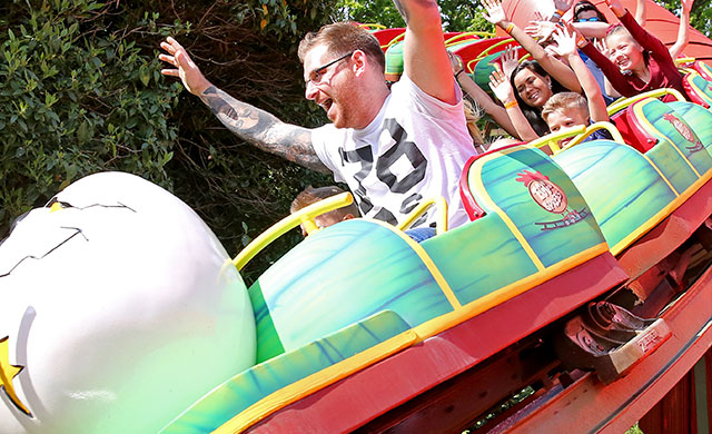 People with hands in the air on a rollercoaster