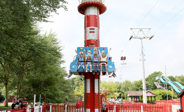 Distant shot of children on drop tower theme park ride