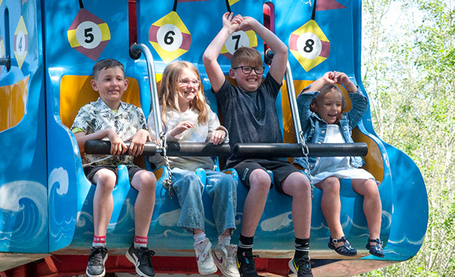 Four children on theme park ride