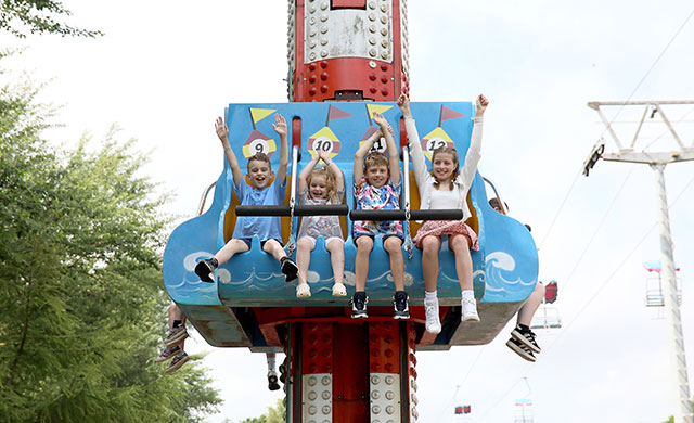 Four young children on amusement theme park ride