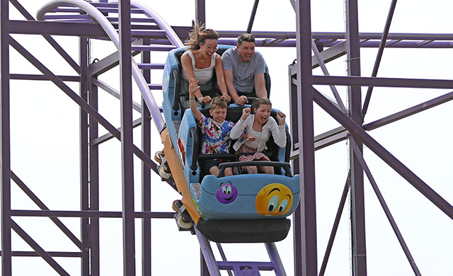 Family on rollercoaster descending at speed