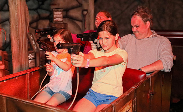 Family on indoor amusement park ride