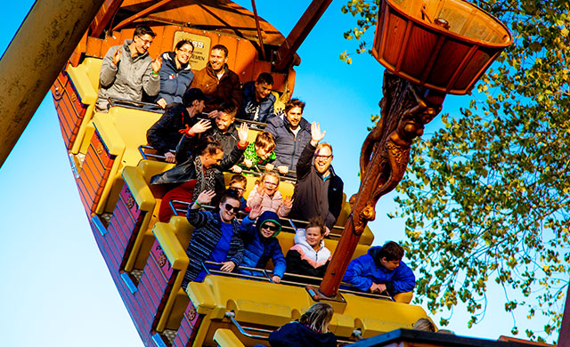 People on pirate ship theme park ride