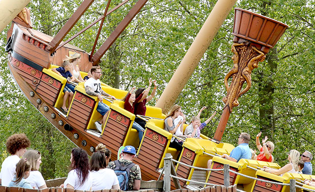 People on pirate ship amusement park ride