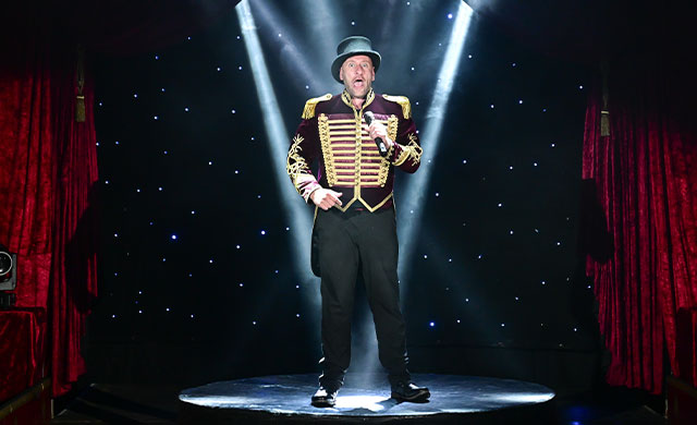Circus ringmaster under spotlight