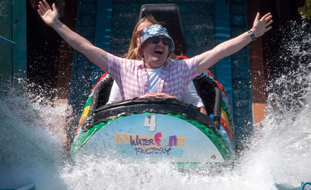 Man and woman on a log flume ride
