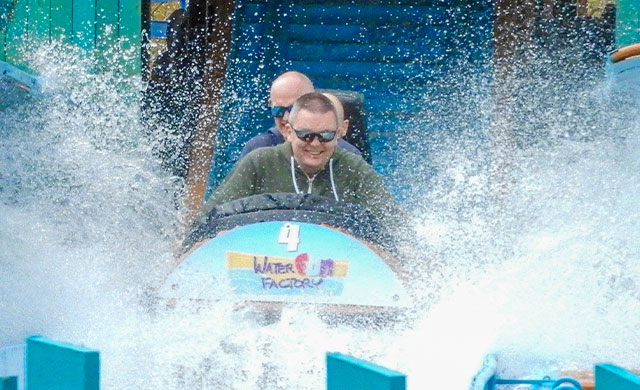 Two men on a log flume splashing