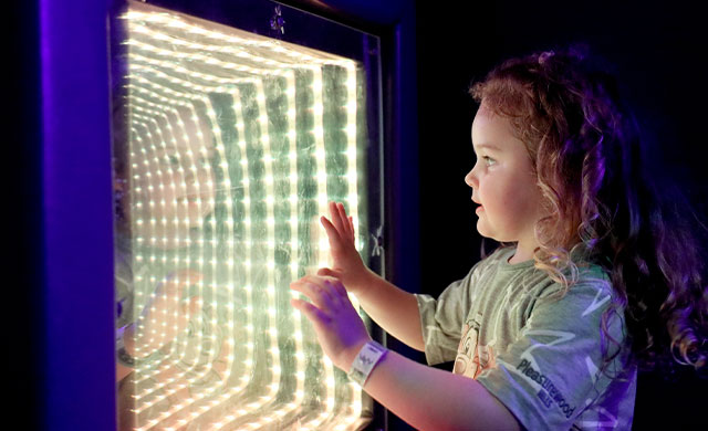 Young girl with wall light in sensory room